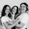 Untitled (Left to Right) Erin Dellorso, Allie Jennings, and Izzy Roland huddled close to each other.